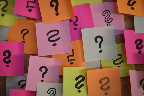 Handwritten different question marks on red, pink, white, yellow and orange sticky notes - Photo, Image