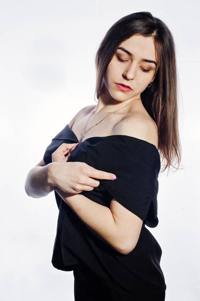 Close-up emotional portrait of a brunette girl in black jumpsuit on white background. - Foto, Imagem