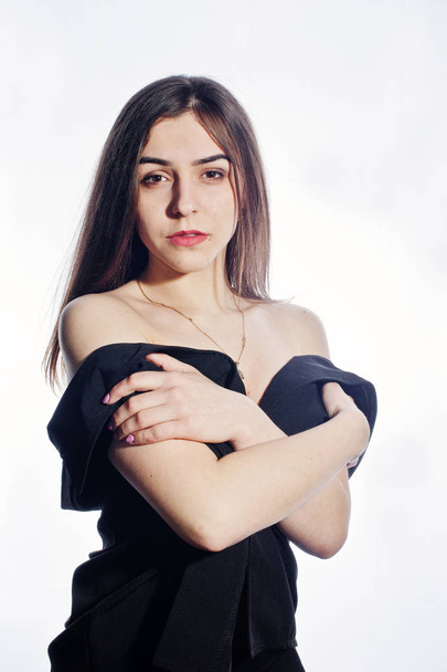 Close-up emotional portrait of a brunette girl in black jumpsuit on white background. - Fotografie, Obrázek