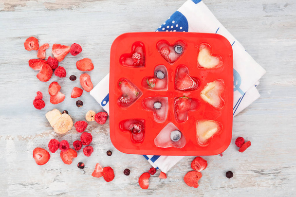 Ice tray with fruit on white background top view. Dehydrated freeze dried fruit. - Photo, Image