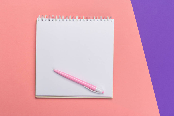 Blank paper notepad on bright bicolor background for your design, top view - 写真・画像
