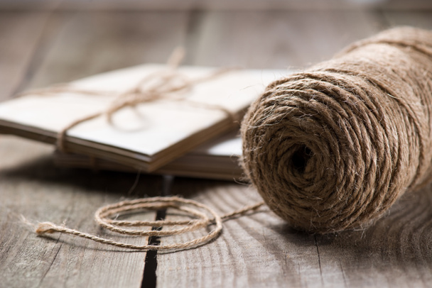 selective focus of beige string with wrapped letters on wooden background  - Zdjęcie, obraz