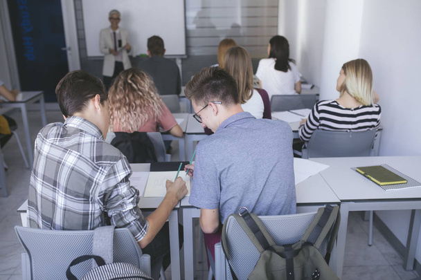 Group of a high school students having a class at modern classroom. - Foto, Imagem