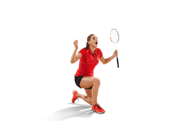 Young woman badminton player as winner posing over white background - Φωτογραφία, εικόνα