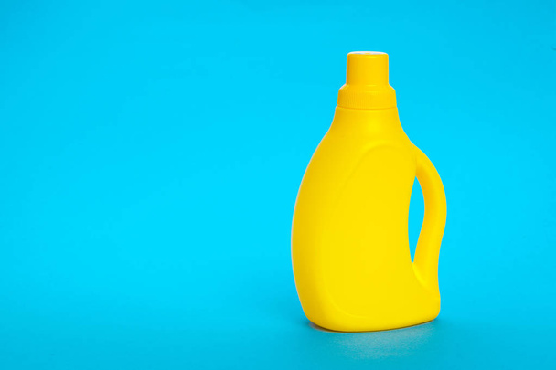 Plastic bottle on blue background - Valokuva, kuva
