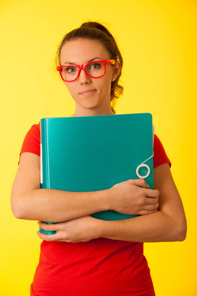 Young geek woman in red t shirt over vibrant yellow background  under stress - Foto, Imagen