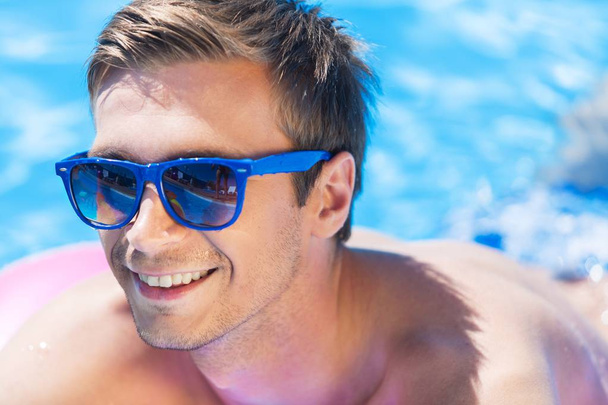 Young Man Having Fun in the Pool - Фото, изображение