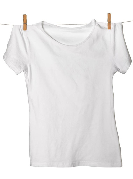 Blank white colored t-shirt hanging on clothesline  - Fotó, kép
