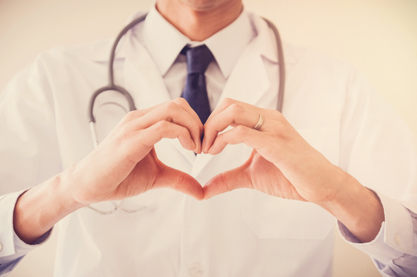 Doctor making hands in heart shape, health insurance concept - Φωτογραφία, εικόνα