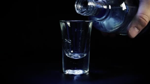 A shot of vodka is poured into a glass - Felvétel, videó