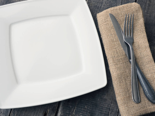 Flatware on a rustic wooden table with space for text - Фото, изображение