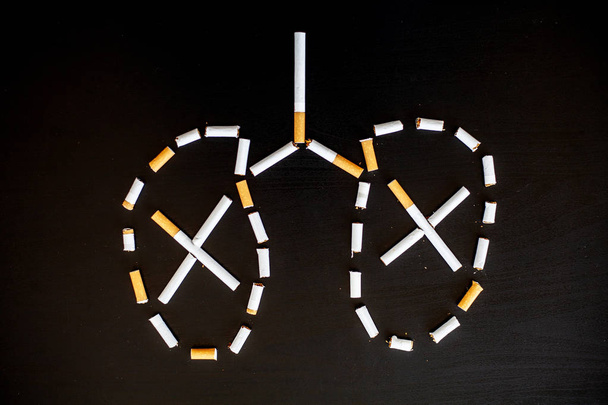 Stop smoking concept on background with broken cigarettes. Heap of cigarettes. No smoking. - Photo, image