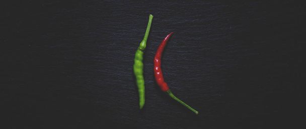 Red and green small hot peppers. Food background.  - Photo, image