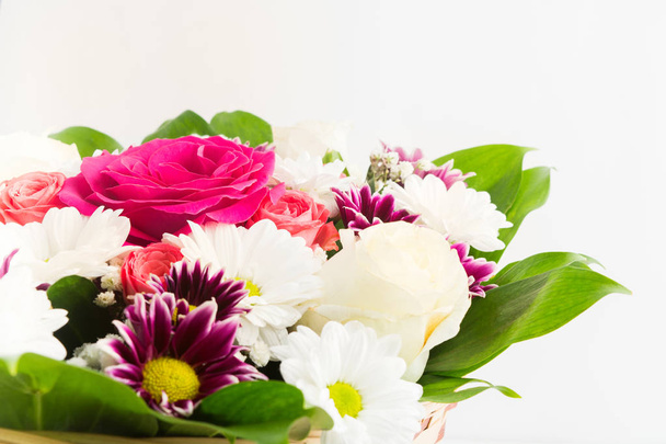 Beautiful flowers bouquet with roses and chrysanthemum in basket on white background - Foto, afbeelding