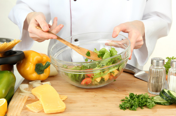 Female hands preparing salad, isolated on white - Foto, immagini