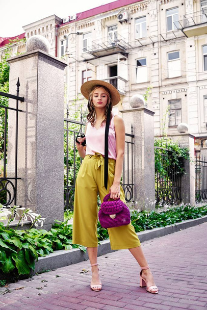 stylish female fashion model posing on the street  - Photo, Image