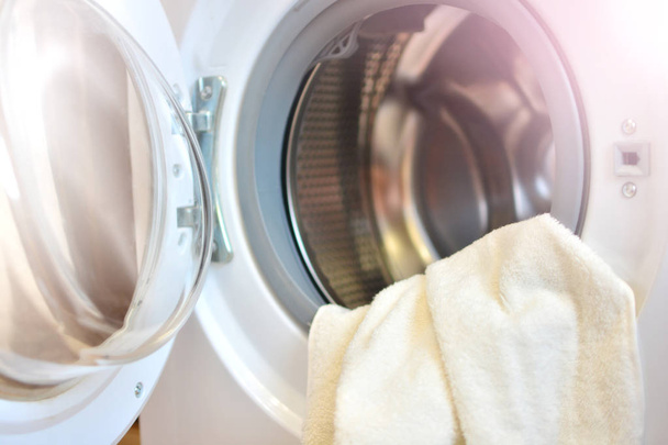 Washing machine with clothes. Open door of washer. - Photo, Image