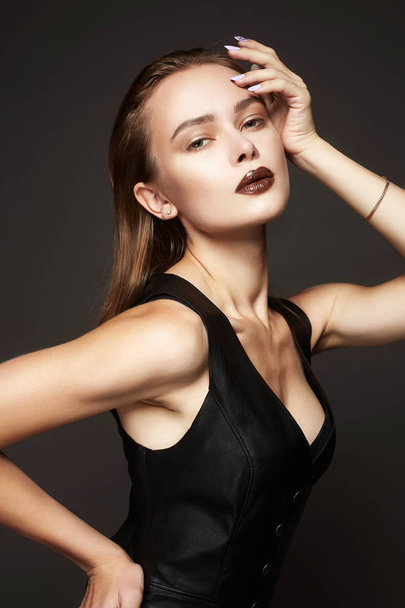 Beautiful young Woman in Leather Dress. Fashionable Girl - Фото, изображение