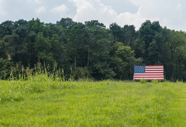 Estrellas y rayas estadounidenses pintadas en tableros de madera en el prado
 - Foto, imagen