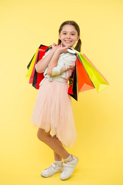 Tips to save money on back to school supplies and clothing. Back to school season teach budgeting basics. Girl carries shopping bags. Prepare for school season buy supplies clothes in advance - Photo, image