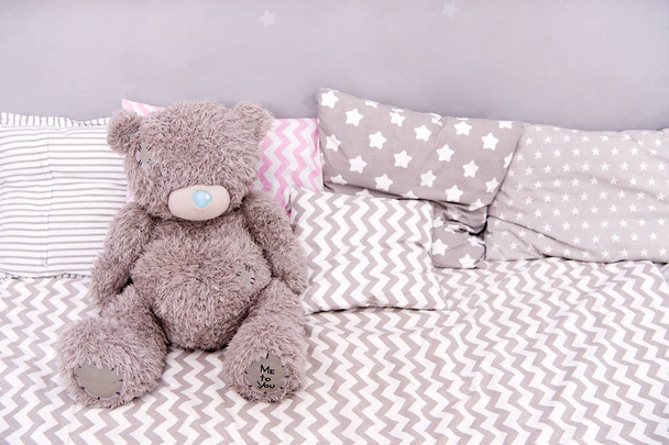 Toy concept. Teddy bear toy. Soft toy on bed. Your real toy shop - Photo, Image