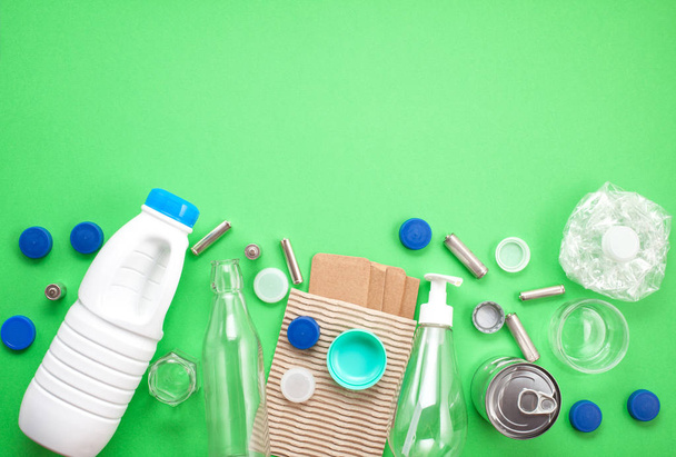 Flat lay of different wastes wastes ready for recycling. Plastic, glass, paper, tin cans. Social responsibility, ecology care concept - Фото, изображение