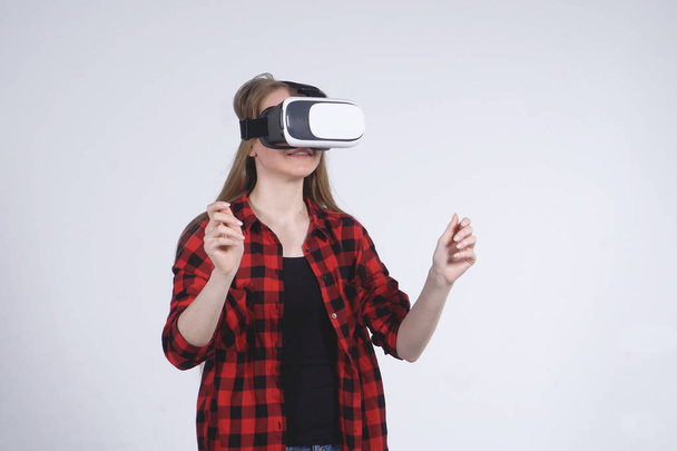The Young Girl in the Virtual Reality Helmet is Actively Playing the Game - Foto, Imagem