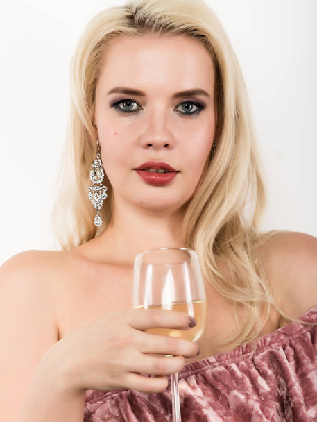 elegant blonde woman holding glass of champagne. celebration concept - Фото, зображення