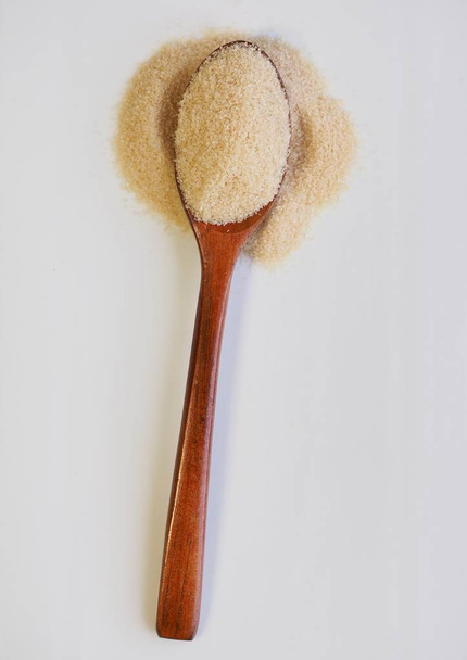 Brown powdered sugar in a spoon - Foto, imagen