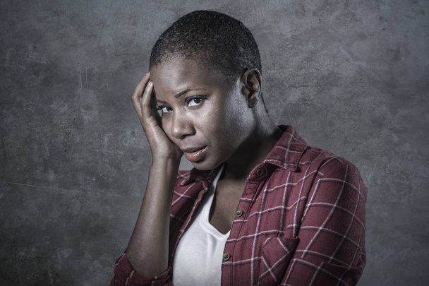 lifestyle isolated portrait of young attractive and sad black afro American woman feeling unwell and depressed and suffering pain looking desperate in sadness emotion face expression - Foto, Imagem