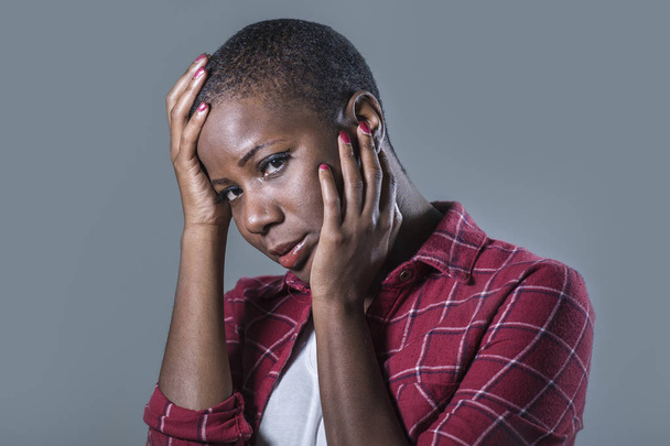 lifestyle isolated portrait of young attractive and sad black afro American woman feeling unwell and depressed and suffering pain looking desperate in sadness emotion face expression - Фото, изображение