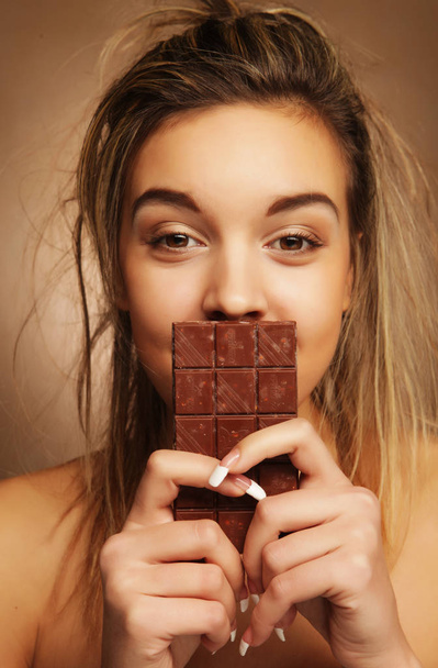 lifestyle, people and food concept: Beautiful girl with chocolate - Фото, изображение