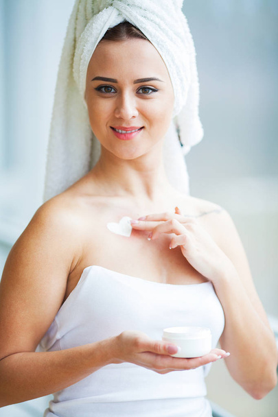 Beauty Face Care. Woman Applying Cream On Skin. - Photo, Image