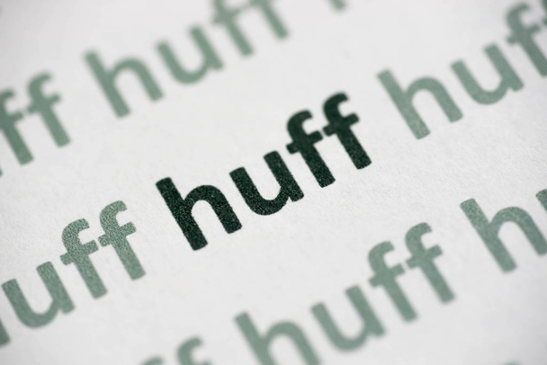 word huff printed on white paper macro - Photo, Image