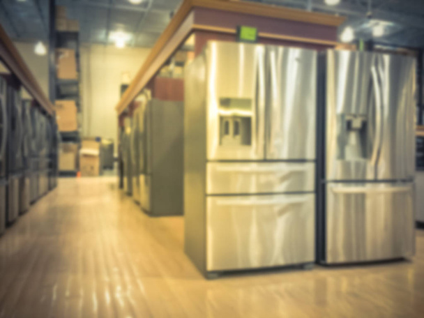 Vintage tone defocused brand new wide selection of French door refrigerators. Row of stainless steel fridges at Irving, Texas, USA. Motion blurred retail store home appliances equipments - Photo, Image