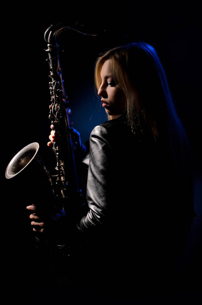 Saxophonist, illuminated by blue and white light - Фото, зображення