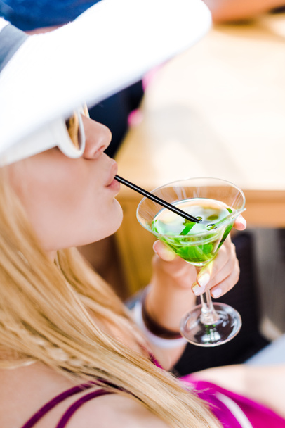 attractive girl drinking cocktail with straw - Zdjęcie, obraz