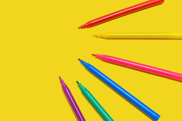 set of colored felt pens on a yellow surface - Фото, зображення