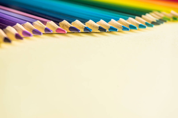 Art concept - Top view of color pencil wave on yellow paper background for mockup design - Foto, immagini