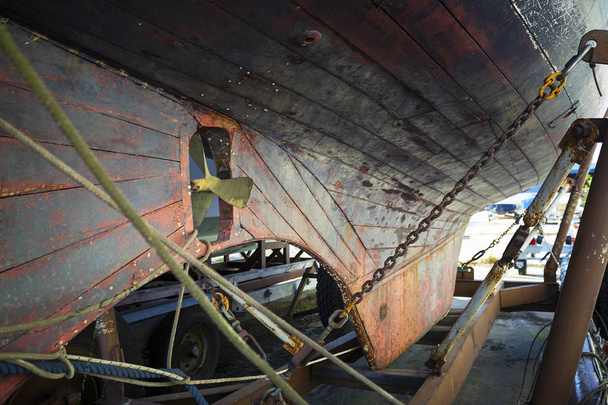 The hull of an old yacht being repaired in a shipyard. - Photo, Image