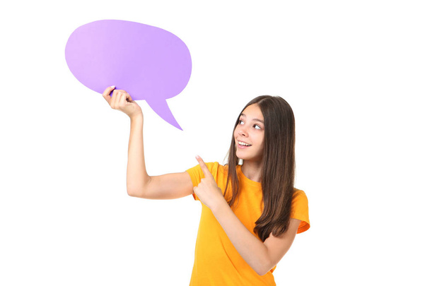 Young girl holding speech bubble and pointing finger at it isolated on white background - Fotoğraf, Görsel