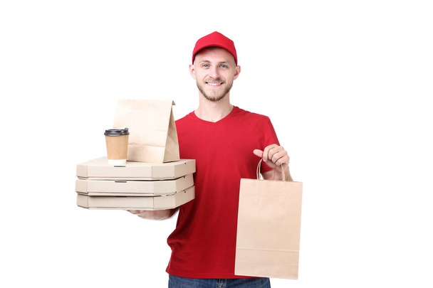 Delivery man holding cardboard boxes with italian pizza and paper bags on white background - Fotoğraf, Görsel