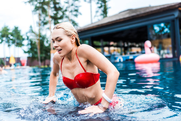 young attractive smiling woman swimming in pool  - Foto, immagini