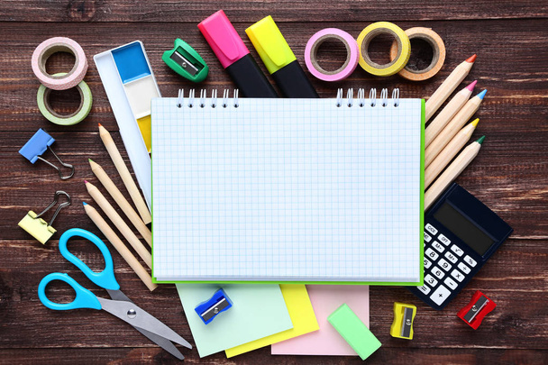 School supplies with blank sheet of paper on wooden table - Photo, Image