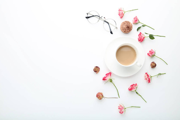 Rose flowers with cup of coffee and macaroon on white background - Фото, зображення