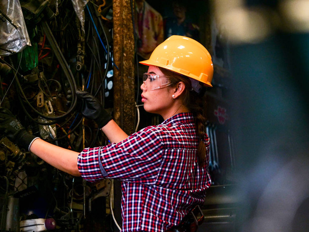 Young Asian Engineer woman  working with machine in factory. - 写真・画像