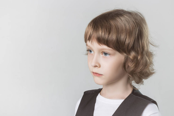 child emotionally posing on camera in the Studio on a white background - Photo, Image
