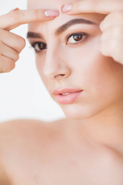 Skin Care. Beautiful Woman Squeezing Pimple at Bathroom Mirror. - Zdjęcie, obraz