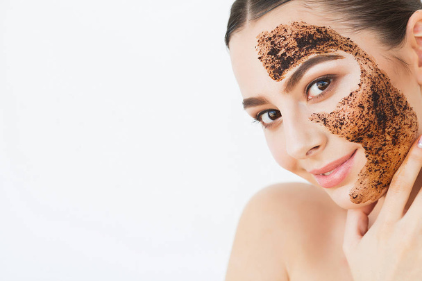 Face Skincare. Young Charming Girl Makes a Black Charcoal Mask on Her Face . - 写真・画像