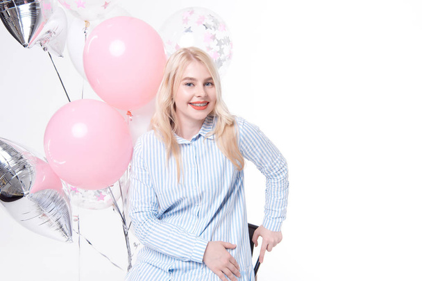 beautiful blonde woman in blue striped dress posing with balloons isolated on white background - Fotografie, Obrázek